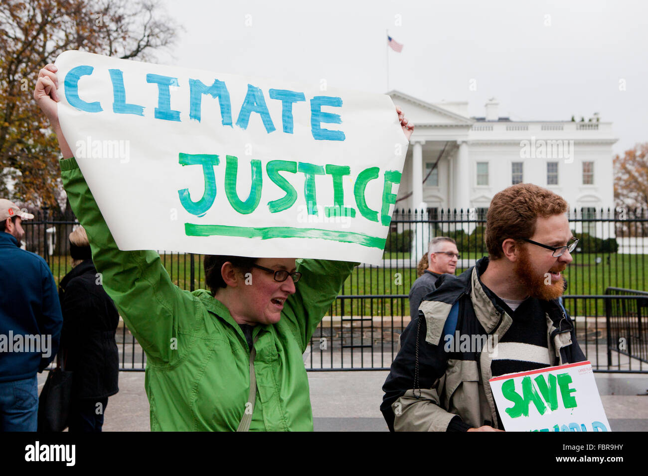 November 21, 2015, Washington, DC USA: Environmental activists protest in front of the White House (woman holding 'Climate Justice' sign Stock Photo