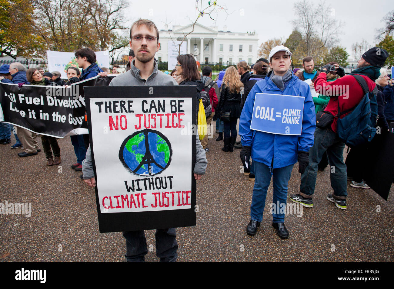 November 21, 2015, Washington, DC USA: Environmental activists protest in front of the White House (man holding 'Climate Justice' sign Stock Photo