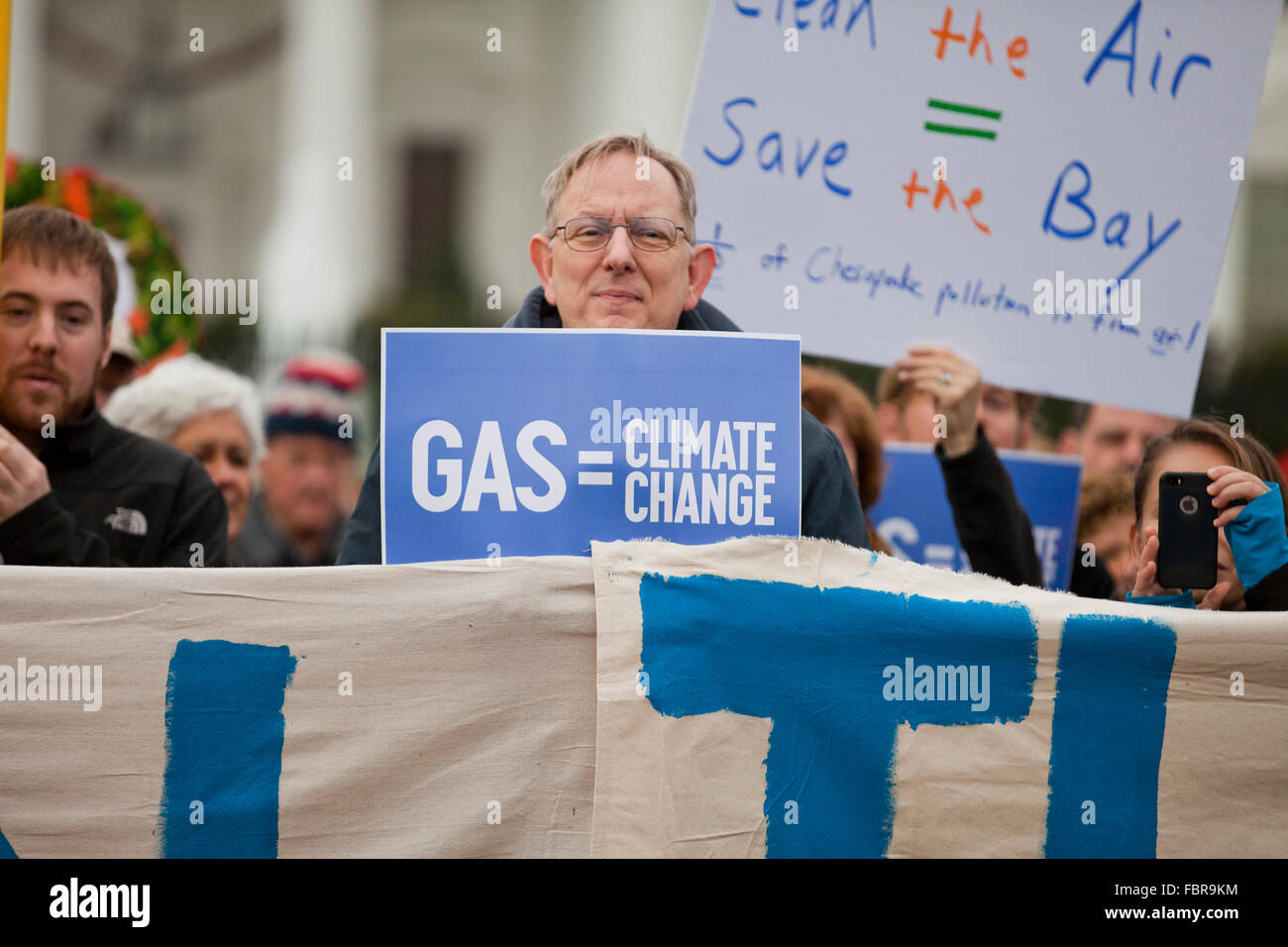 November 21, 2015, Washington, DC USA: Environmental activists protest in front of the White House (man holding 'Gas = Climate Change' sign) Stock Photo