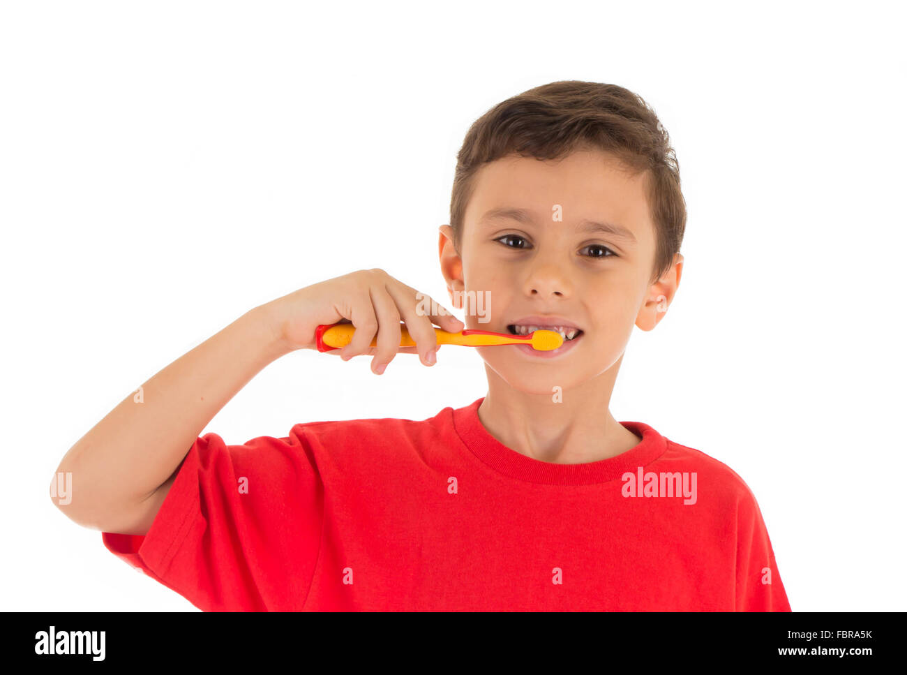 Young kid brushing his teeth Stock Photo