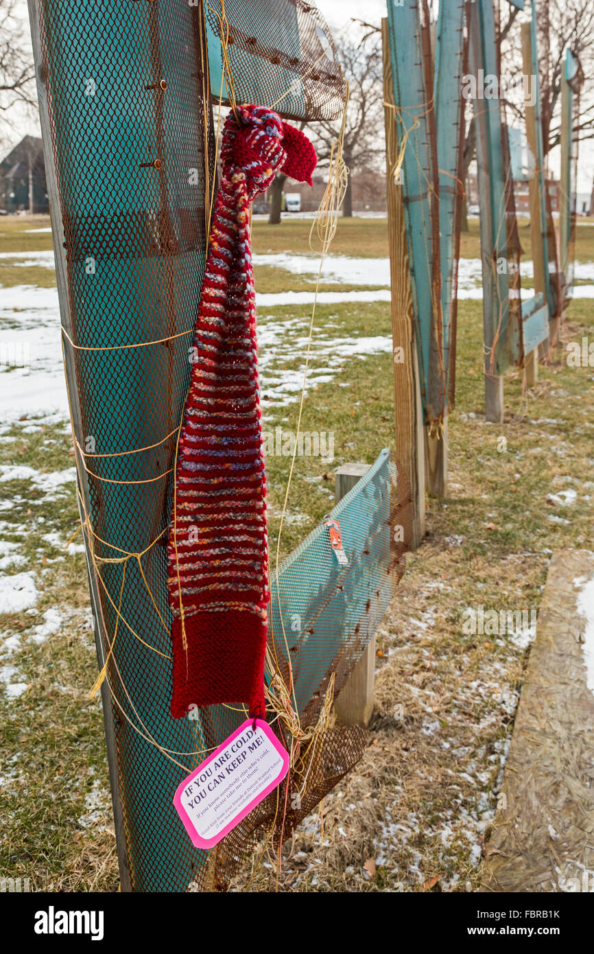 Detroit, Michigan - A hand-knit scarf hangs on a sign in Roosevelt Park, free for anyone who is cold to claim it. Stock Photo