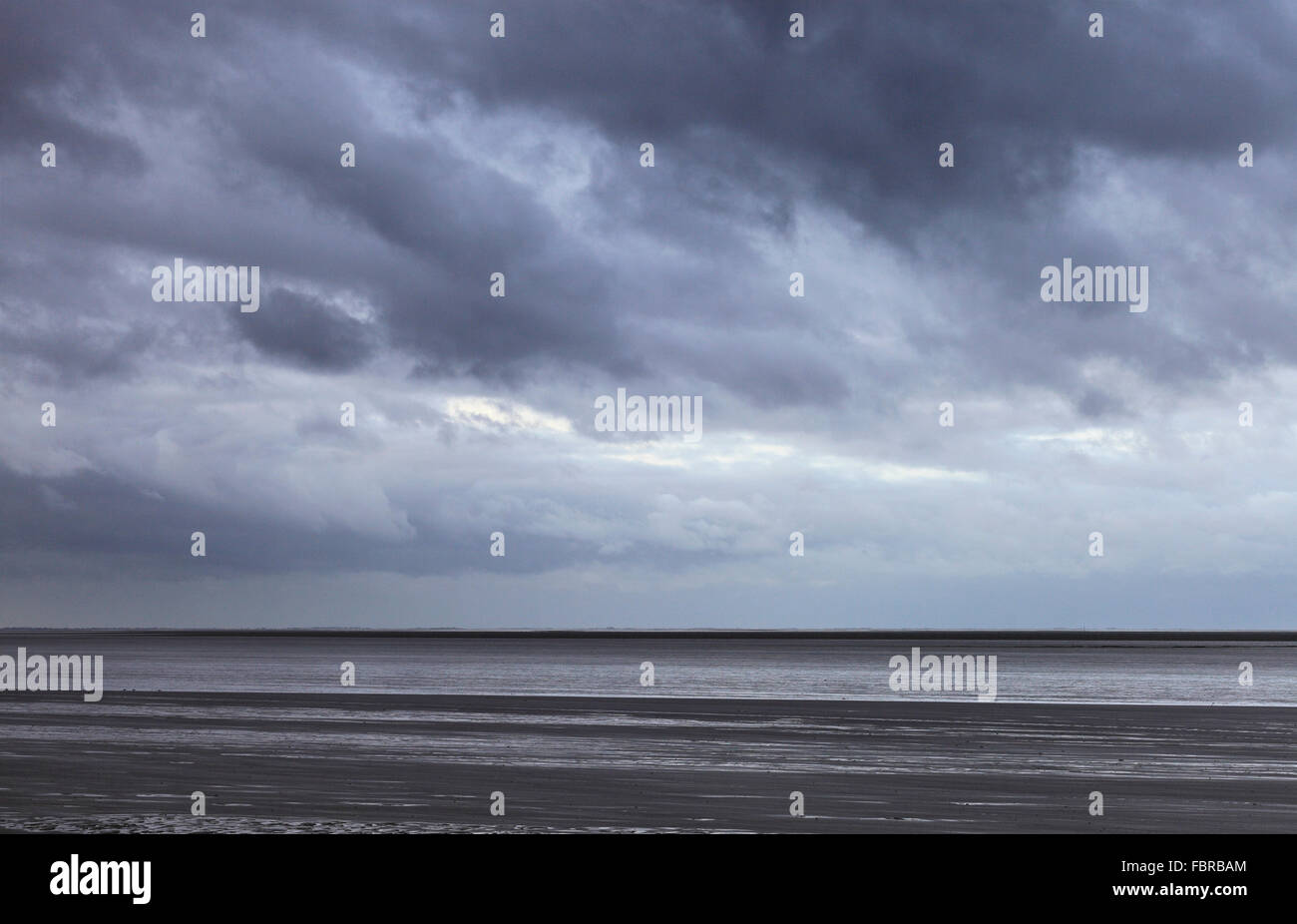 Stormy skies over the mudflats of The Wash estuary. Stock Photo