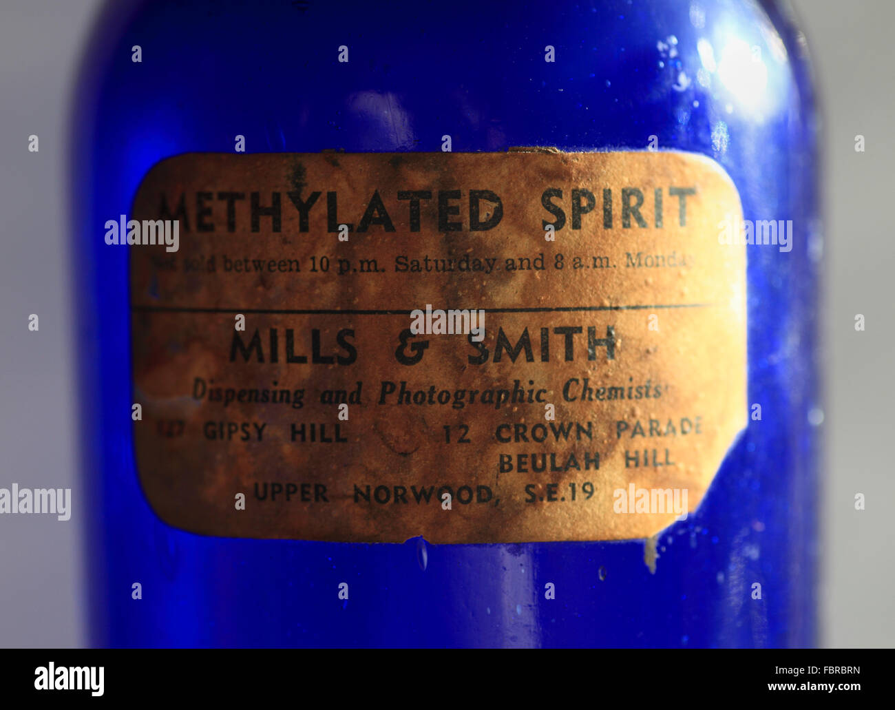 Blue glass methylated spirits bottle with label. Stock Photo