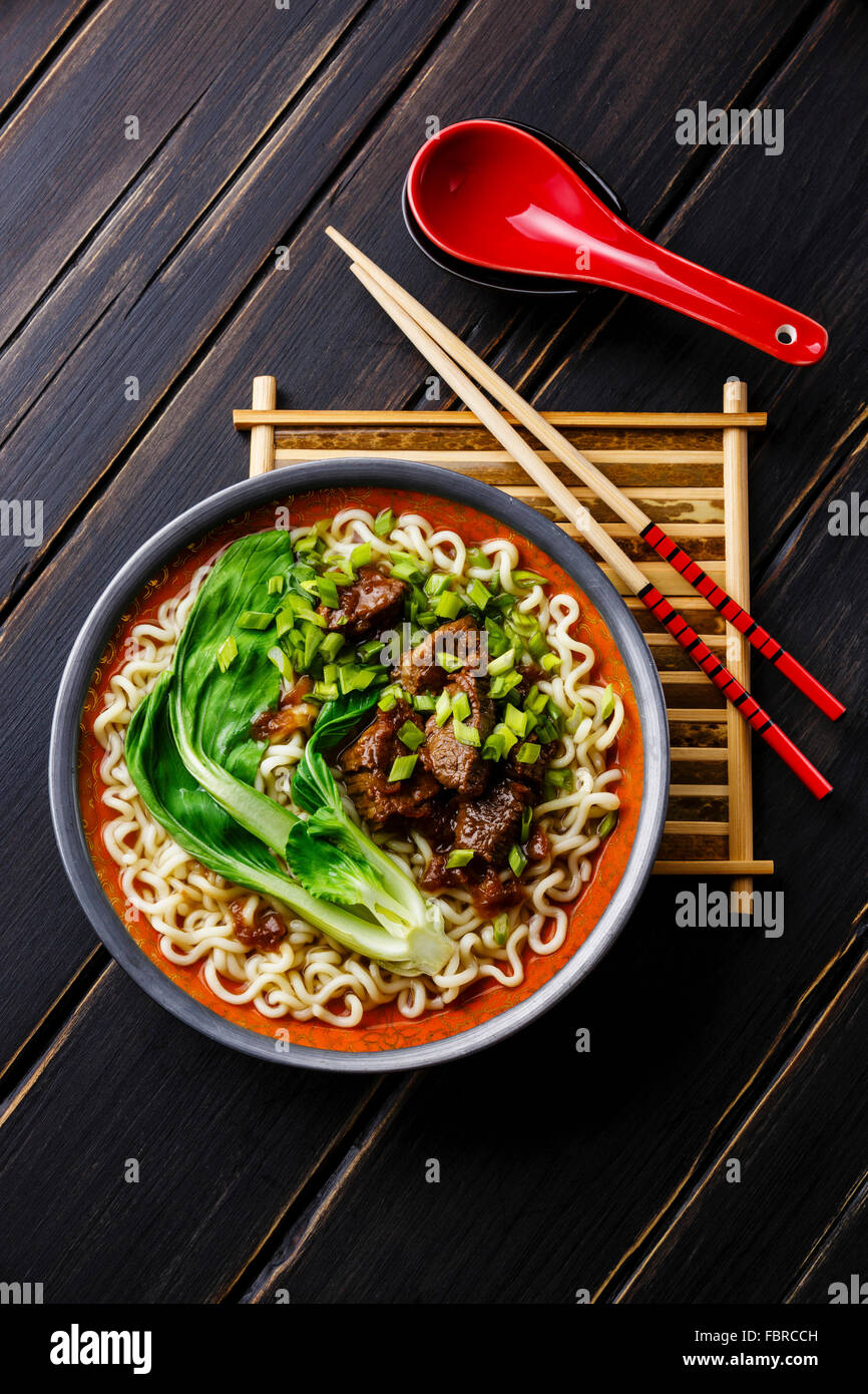 Miso Ramen Asian noodles with beef and pak choi cabbage on dark wooden