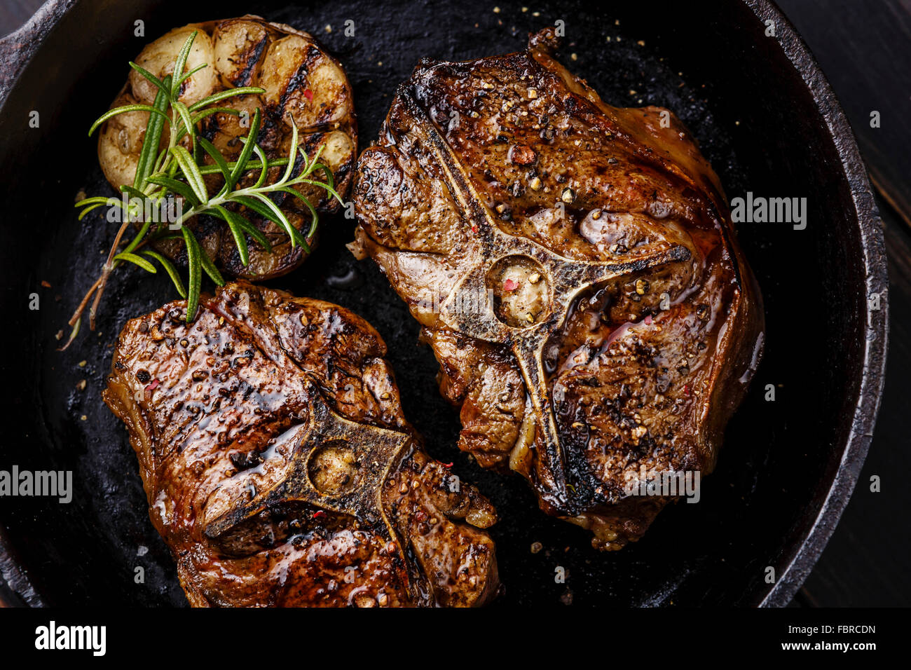 Roasted lamb loin chops with rosemary and garlic on iron pan Stock