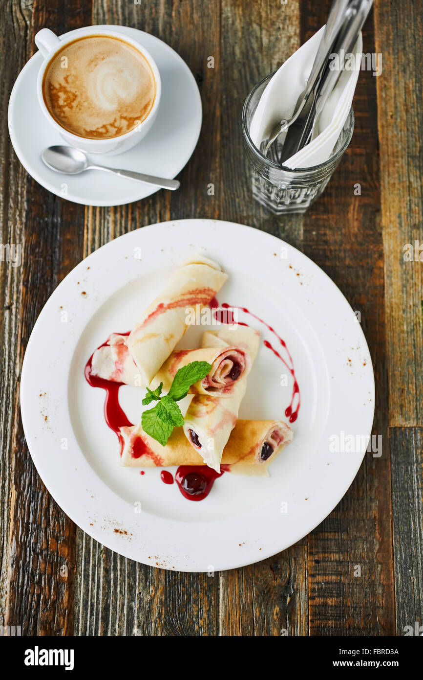 Pancakes With Cottage Cheese And Cherry And A Cup Of Cappuccino On