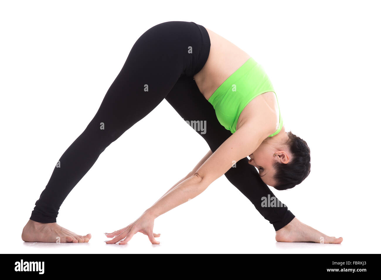 Slender fitness girl workout on white background, Intense Side Stretch yoga Pose, Parsvottanasana, exercise for shoulders Stock Photo