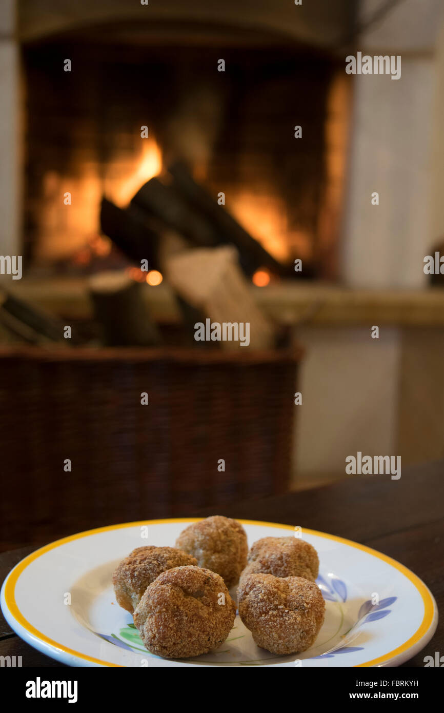 fried chicken balls in a dish in front the fireside Stock Photo
