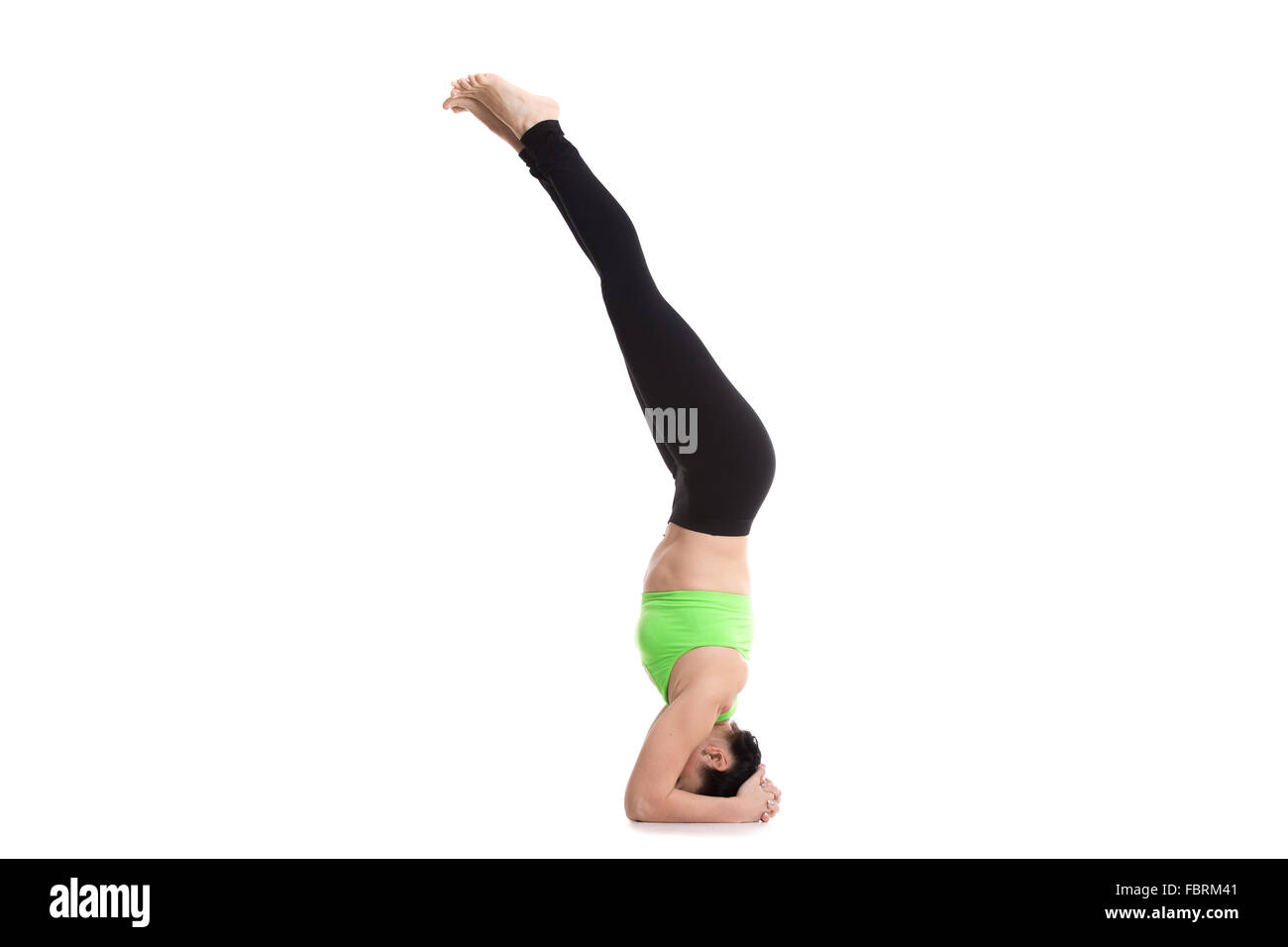 Beautiful sporty girl doing supported headstand yoga asana, salamba sirsasana, Pose for Depression Stock Photo