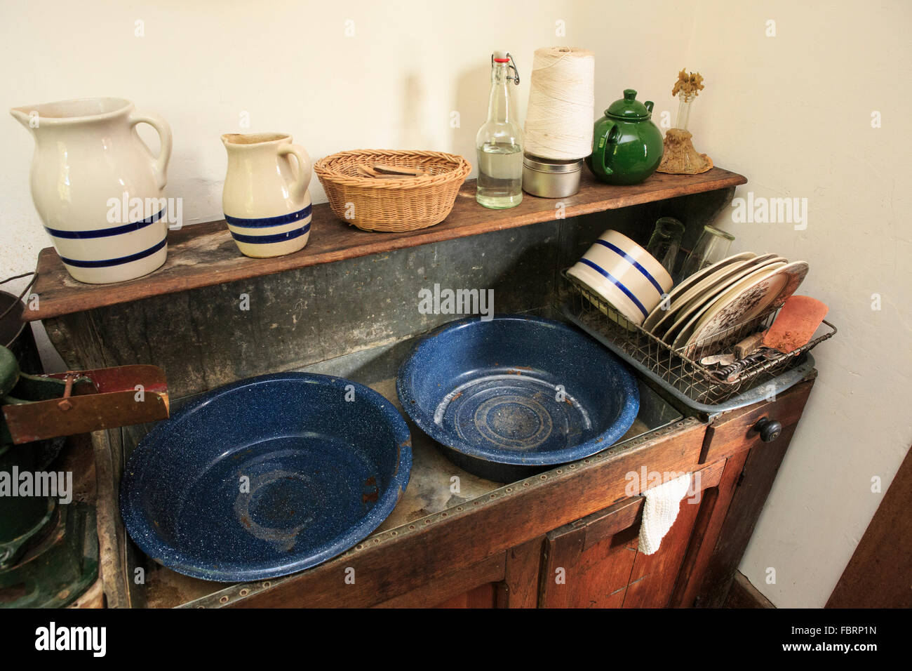 Sink and old dishware in maintained farmhouse. Stock Photo
