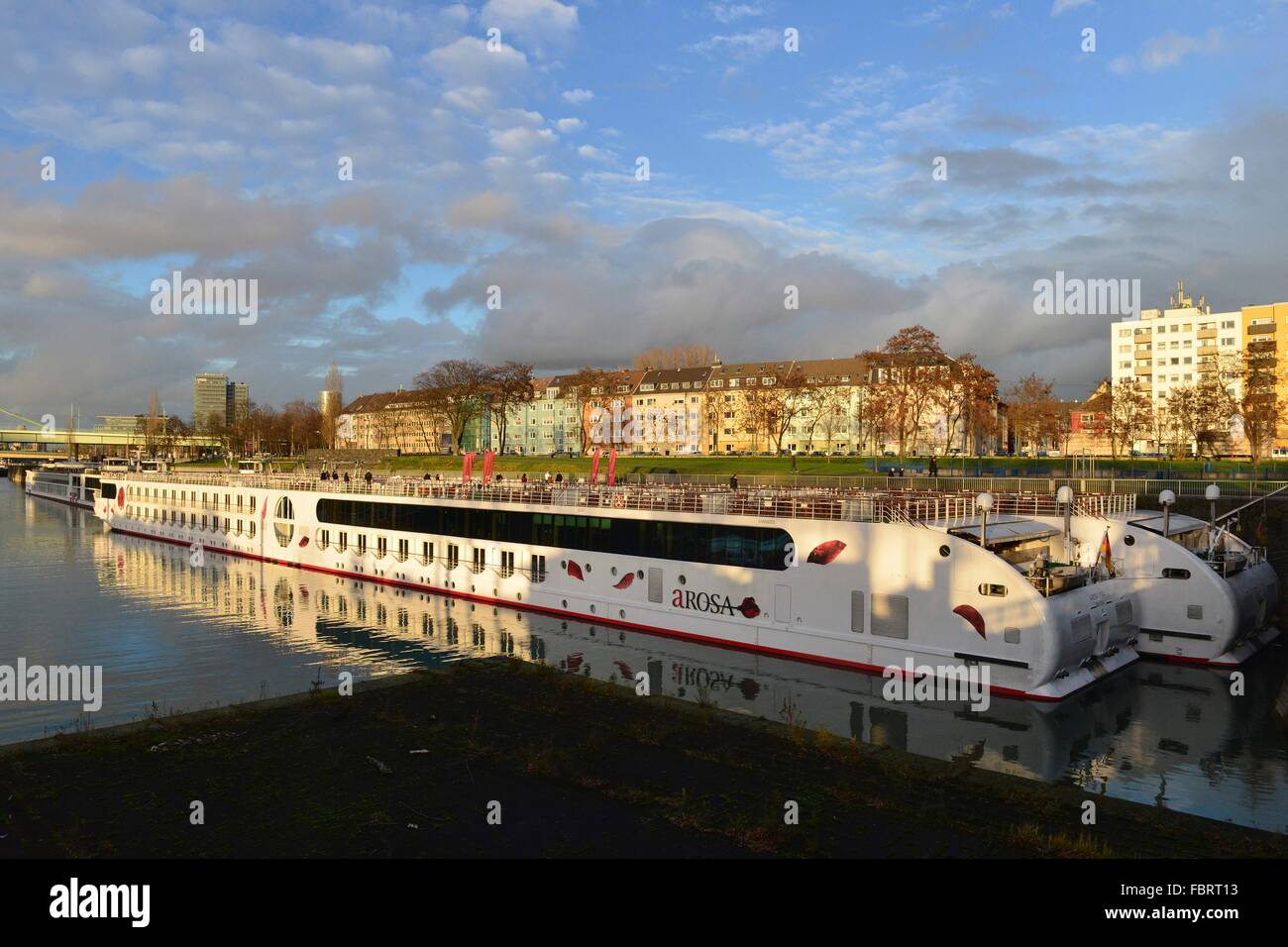 Two white hotel ships in the inland harbour with tenements at the bank of the Rhine in Cologne's district Deutz, 19 December 2013 Stock Photo