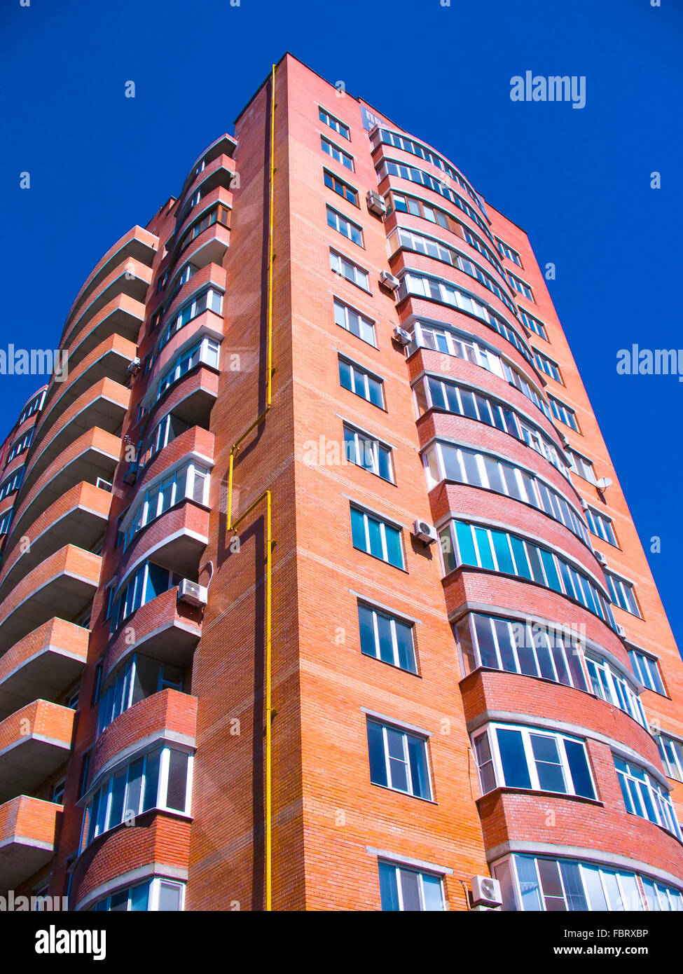 high residential house on blue sky background with trees Stock Photo ...
