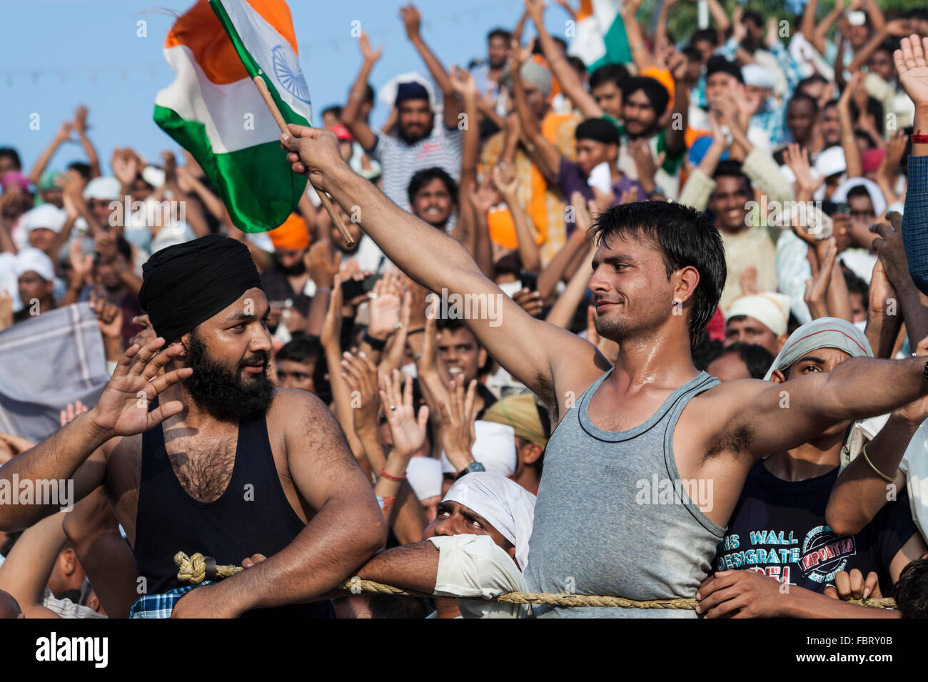 The people cheering ceremony of Indian-Pakistani border crossing. Wagah,Attari Border, Punjab, India. Stock Photo
