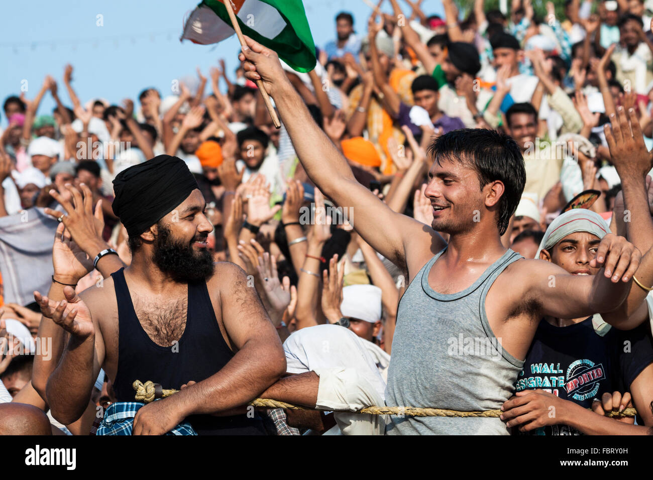 The people cheering ceremony of Indian-Pakistani border crossing. Wagah,Attari Border, Punjab, India. Stock Photo