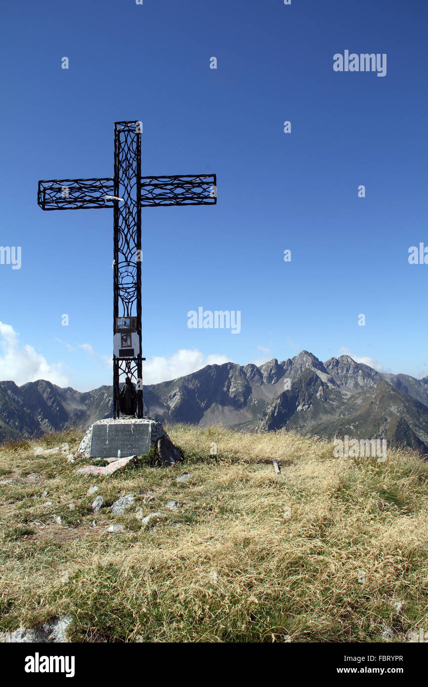 Cross on top of a mountain in Italy Stock Photo