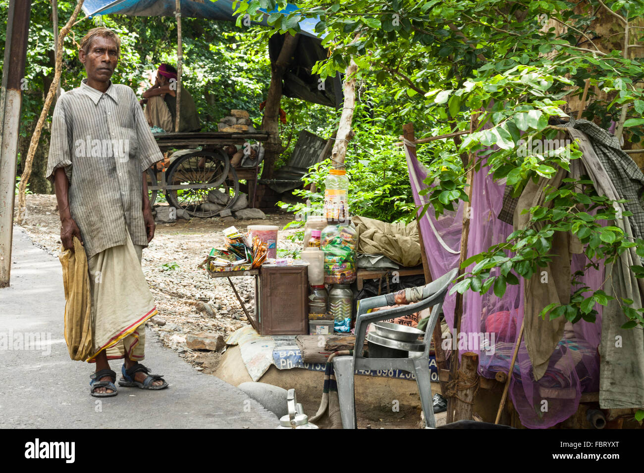 A poor man selling some goods to make a living in Rishikesh, India. Stock Photo