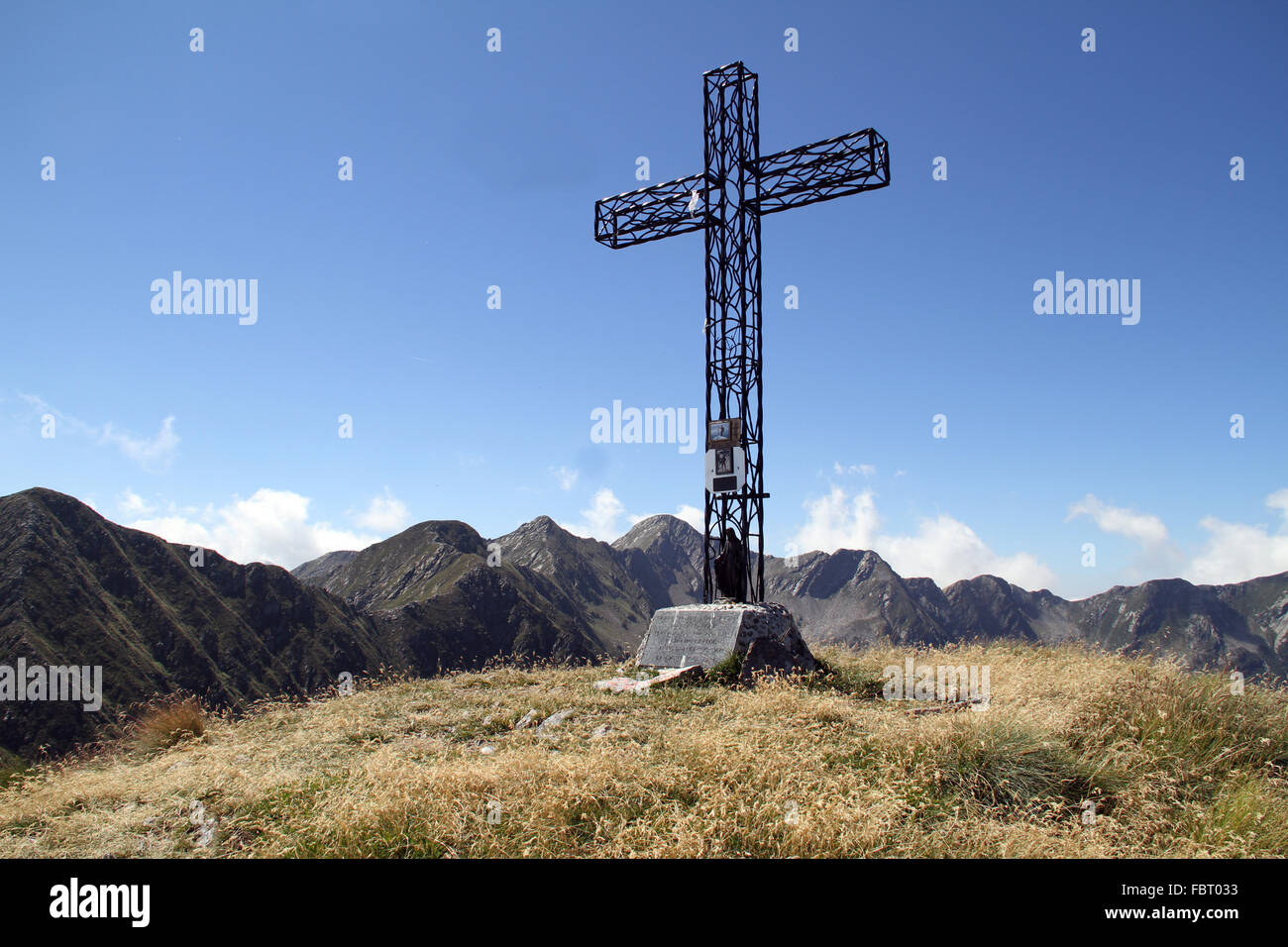 Cross on top of a mountain in Italy Stock Photo