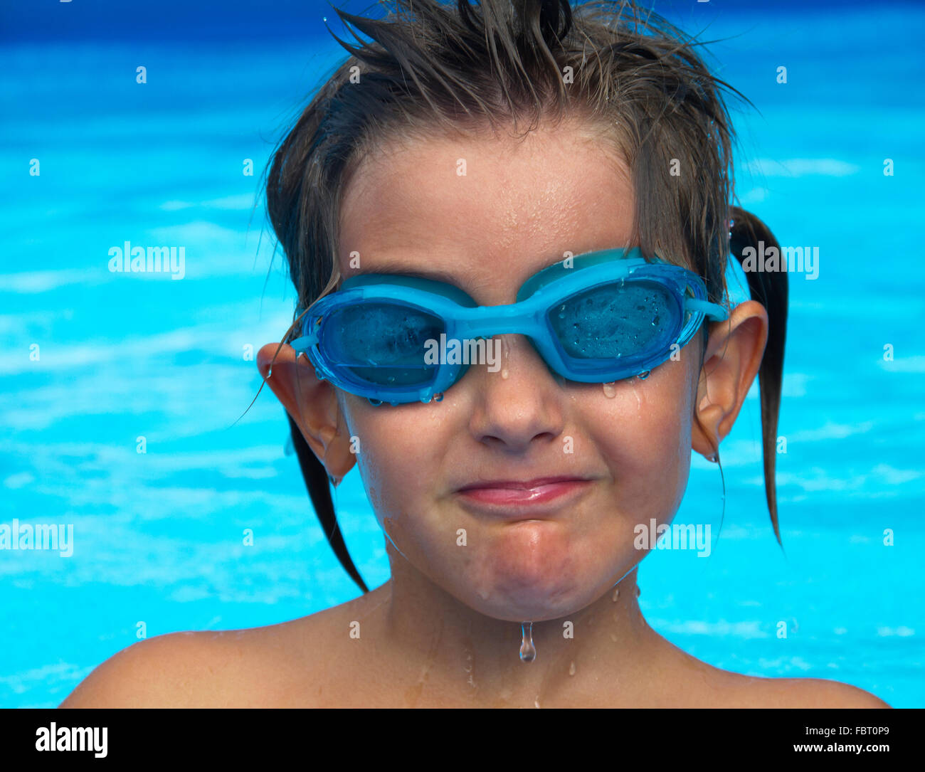 Young girl in the pool with a swimming goggles Stock Photo - Alamy