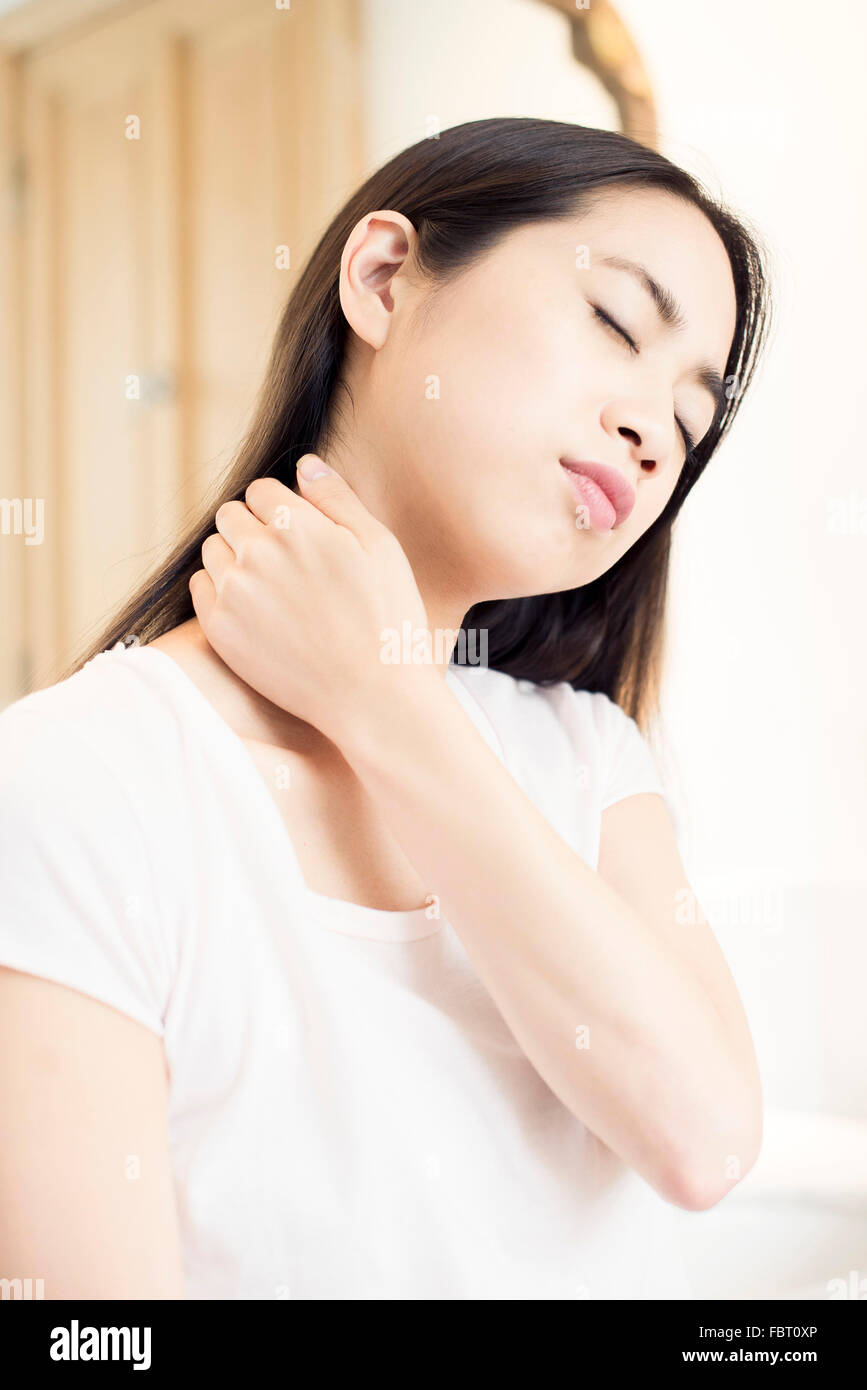 Woman massaging her neck Stock Photo - Alamy