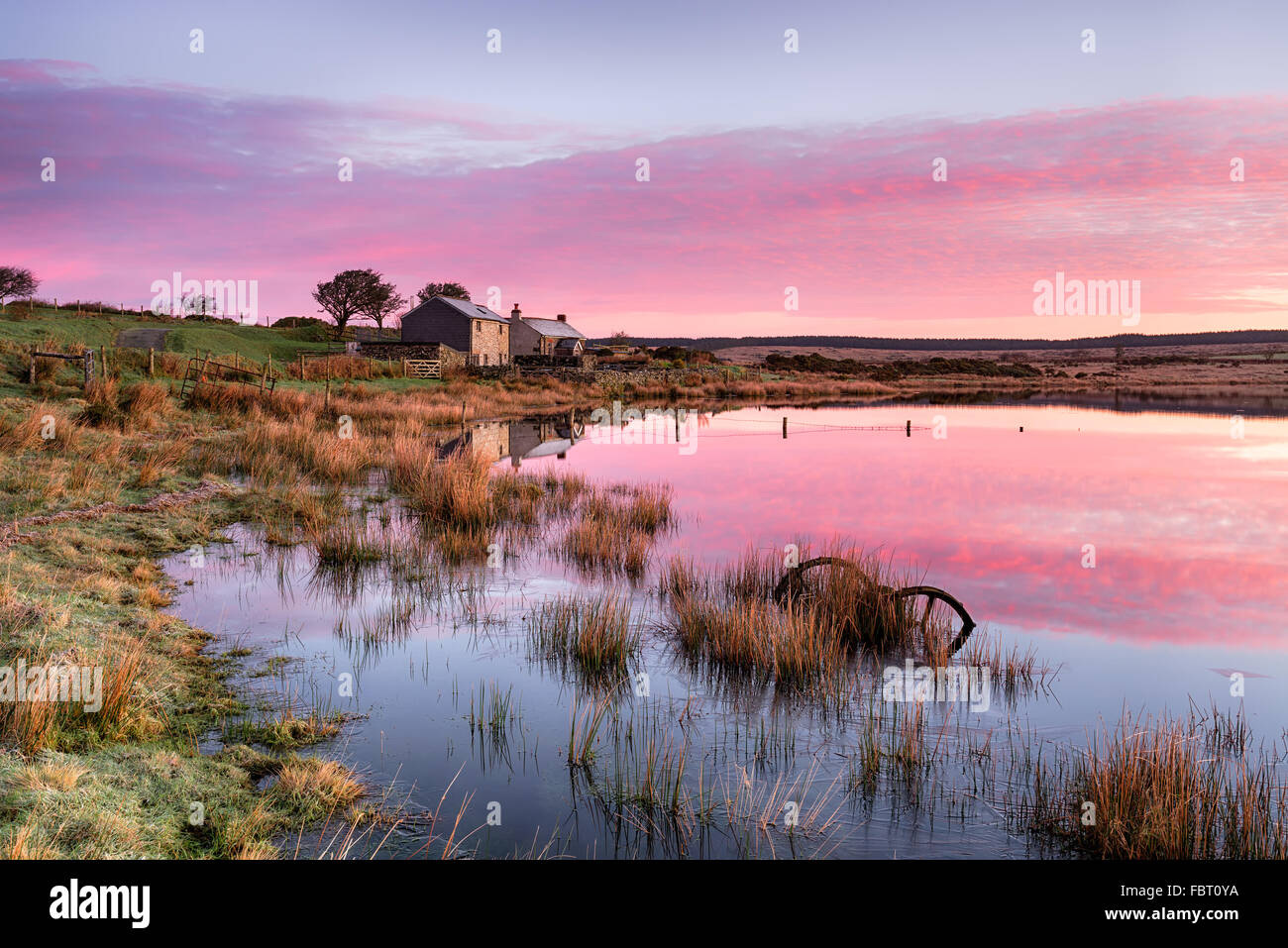 Stunning sunrise over Dozmary Pool on Bodmin Moor in Cornwall, a small