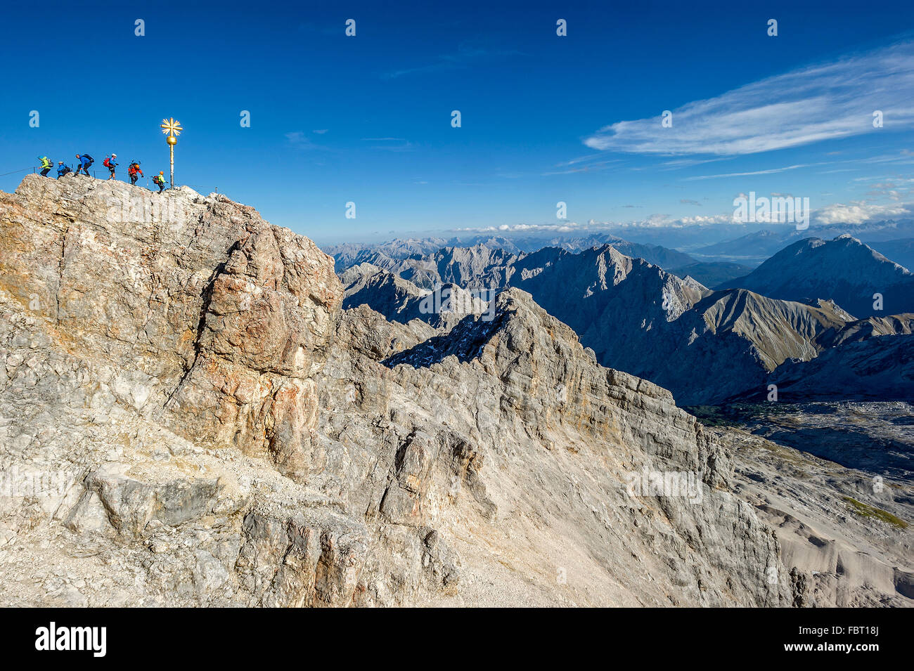 Tourists, summit cross on the Zugspitze, view to Tyrol, Garmisch-Partenkirchen District, Wetterstein, Alps, Upper Bavaria Stock Photo