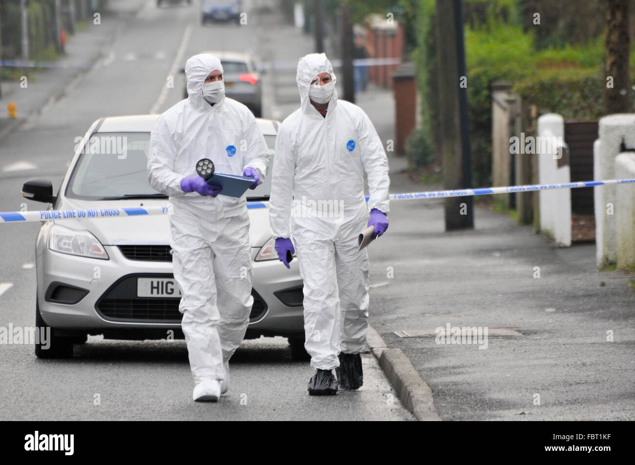 Greenisland, Northern Ireland. 19 Jan 2016 - Two detectives (DCI John McVea on the right) dressed in protective forensic clothing walk up to a murder scene to investigate Credit:  Stephen Barnes/Alamy Live News Stock Photo