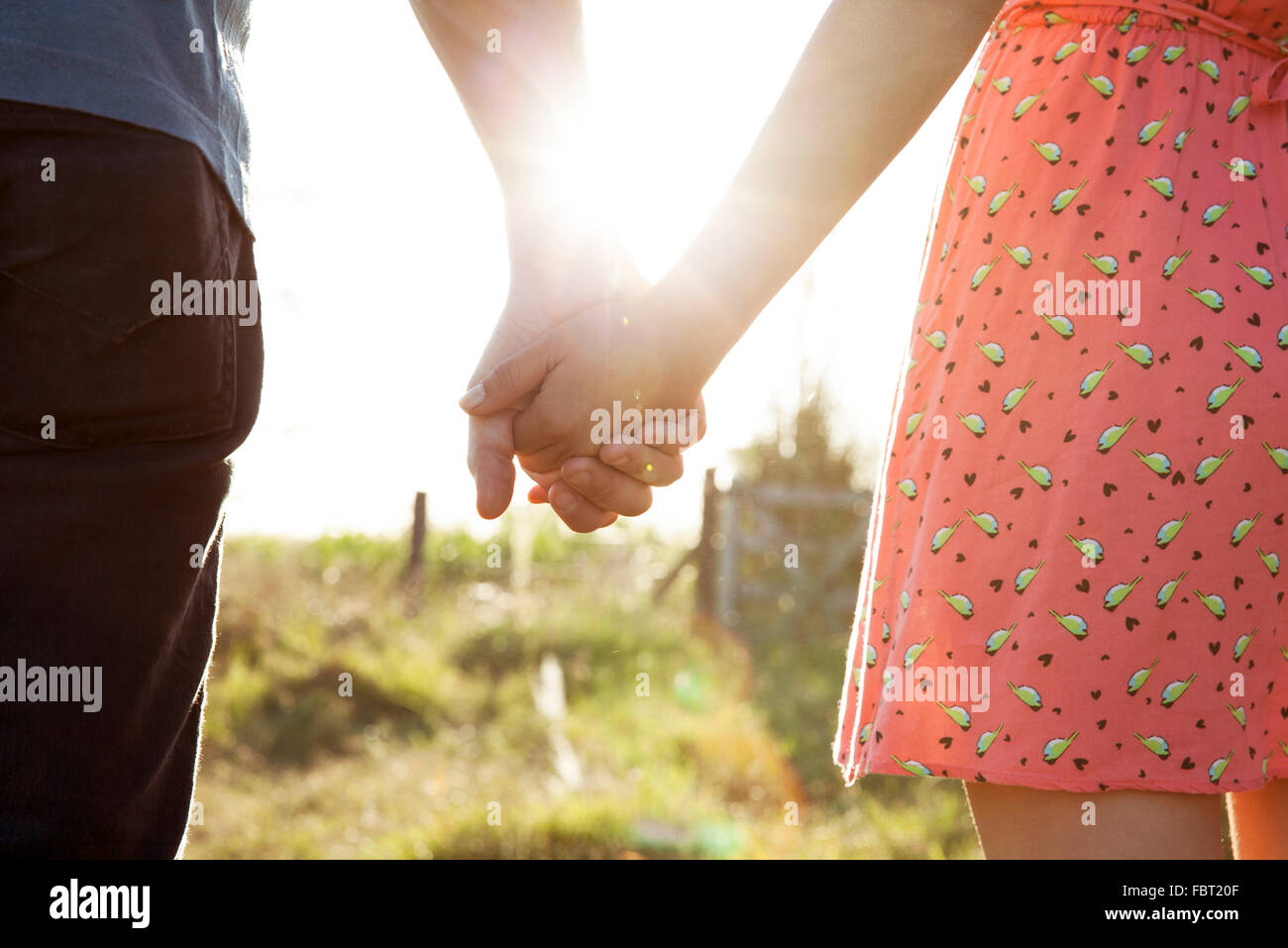 Couple holding hands, close-up Stock Photo