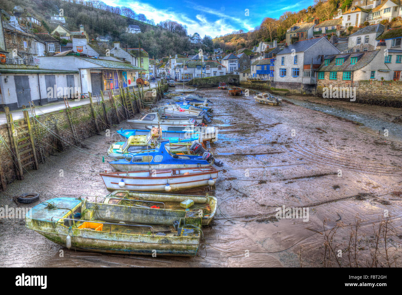 English harbour Polperro Cornwall South West England UK out of season in winter with boats at low tide HDR Stock Photo