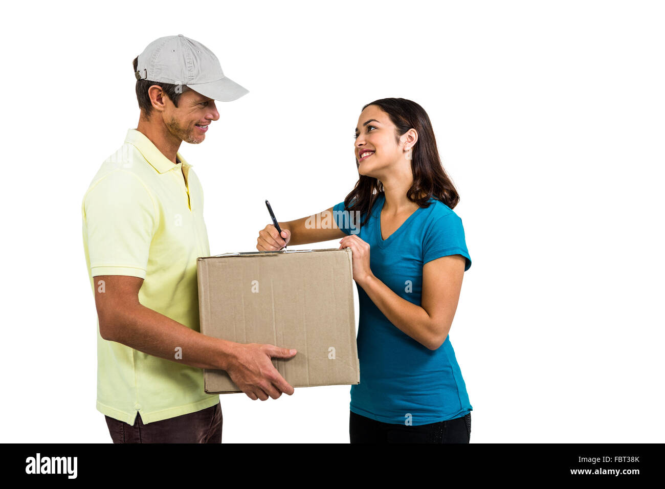 Smiling woman with delivery man holding cardboard box Stock Photo