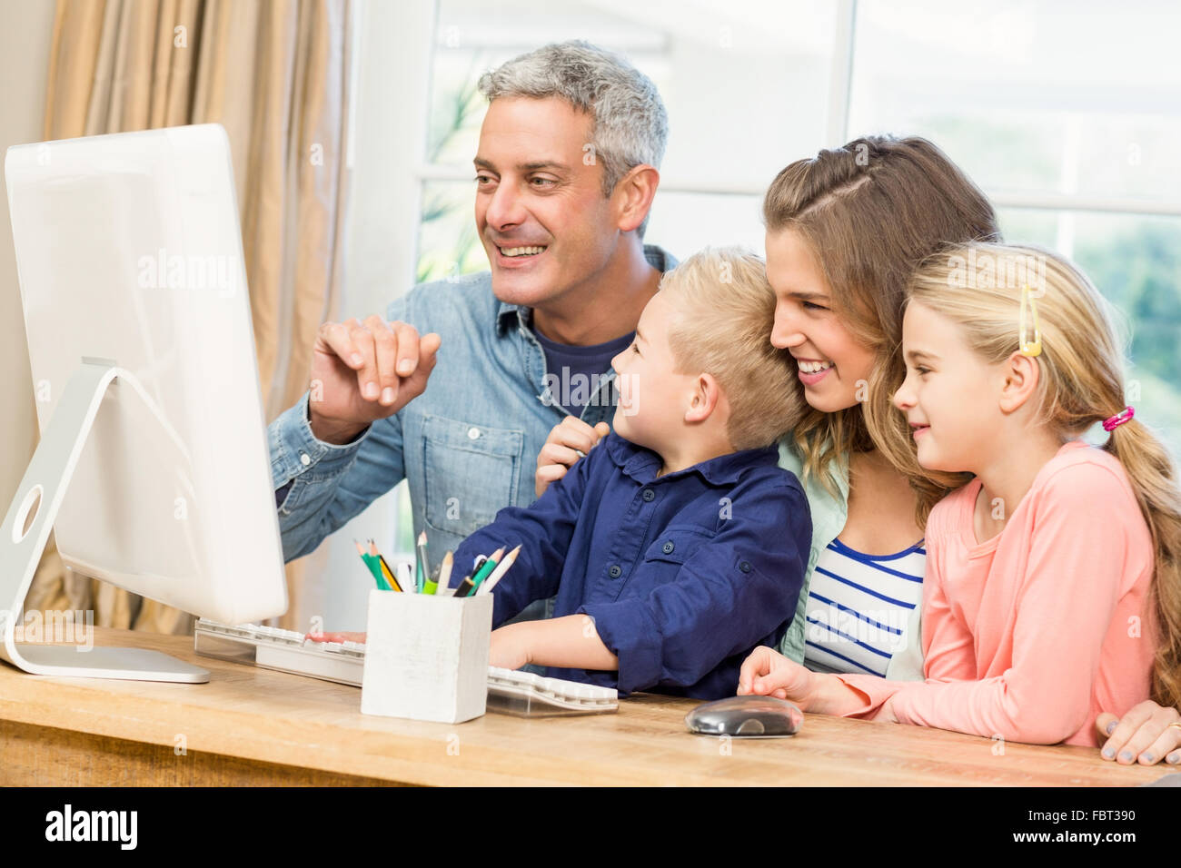 Happy family using the computer Stock Photo - Alamy