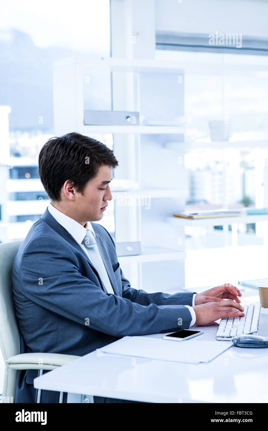 Someone Using His Computer Serious asian male computer hi-res stock photography and images - Alamy