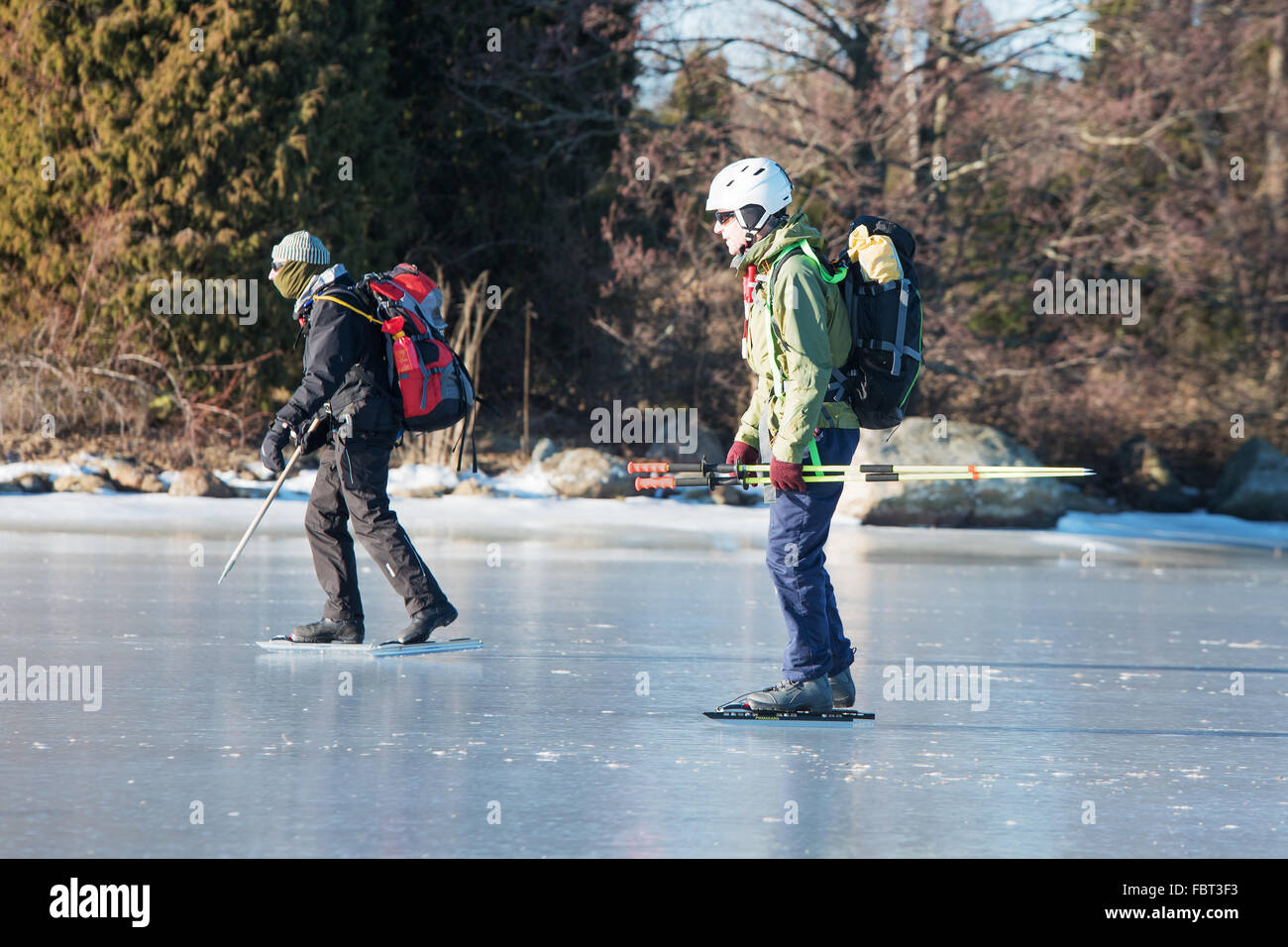Listerby, Sweden - January 17, 2016: Two unknown persons out on a long distance tour skating trip in the archipelago. They have Stock Photo