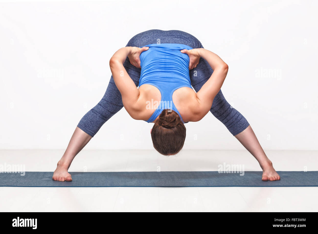 Sporty fit woman practices Ashtanga Vinyasa yoga Stock Photo