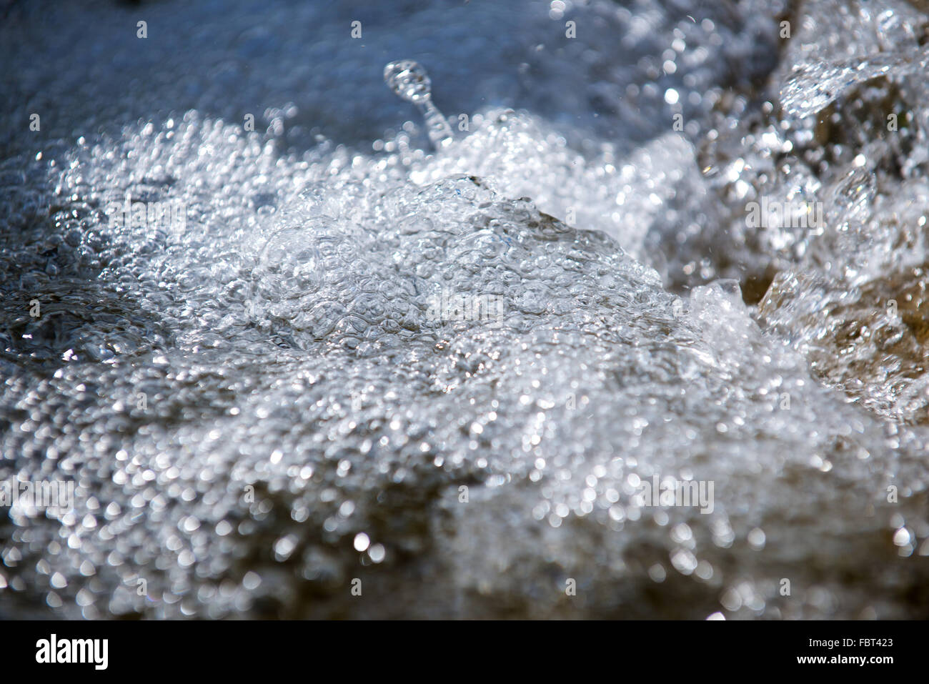 Bubbles on surface of flowing water Stock Photo