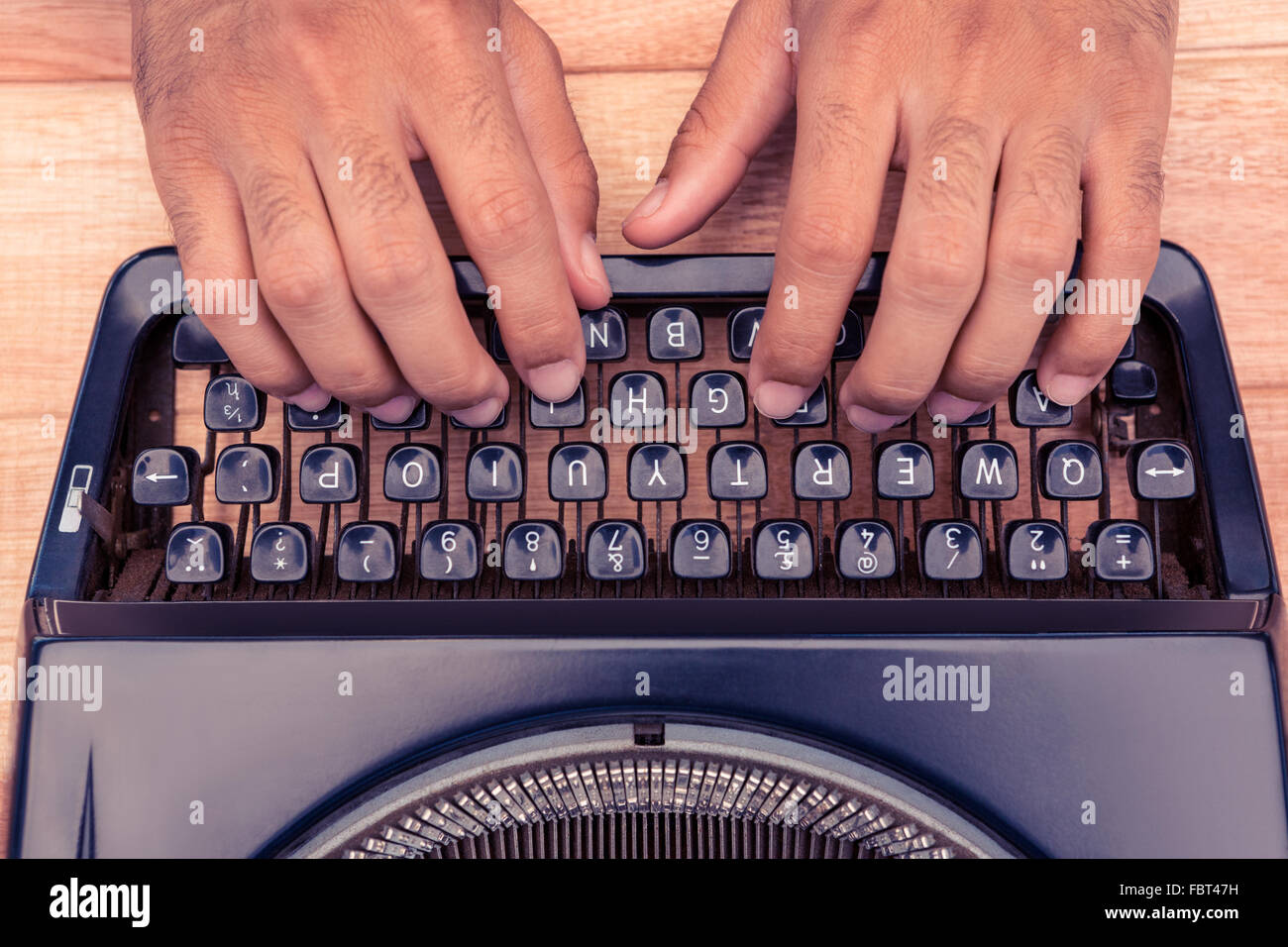 Cropped image of businessman typing on typewriter Stock Photo
