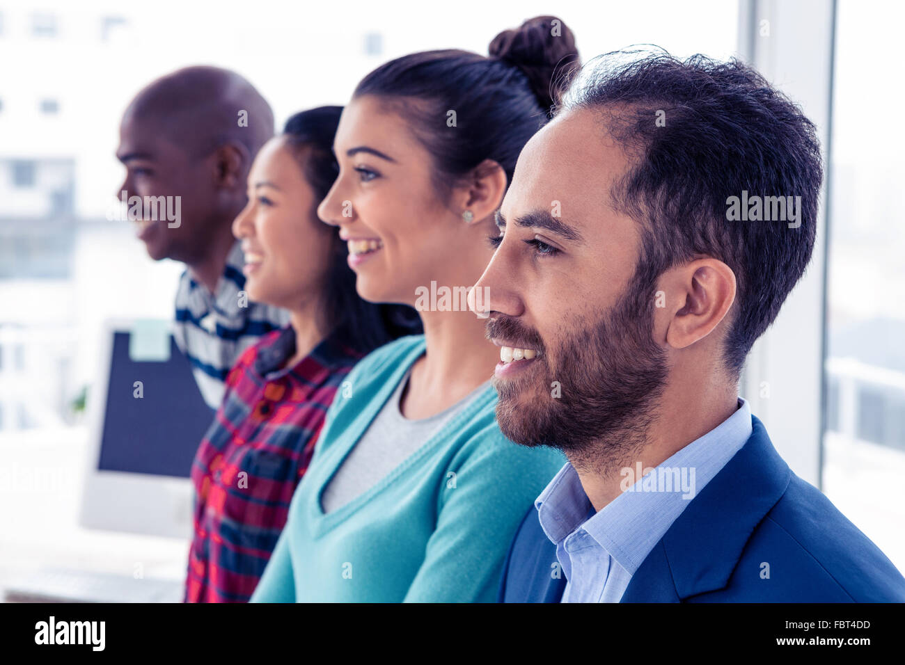 Cheerful business team standing in row Stock Photo - Alamy