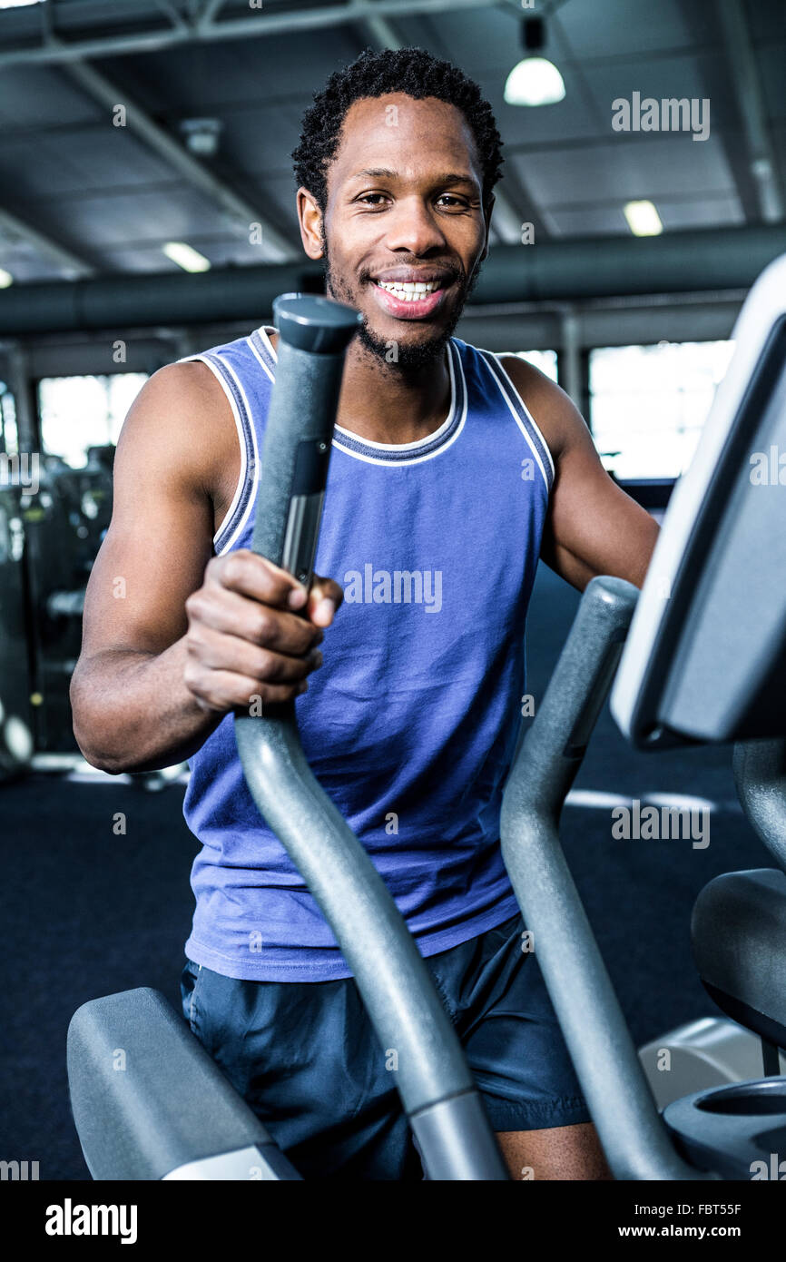 Smiling man working out on the machine Stock Photo