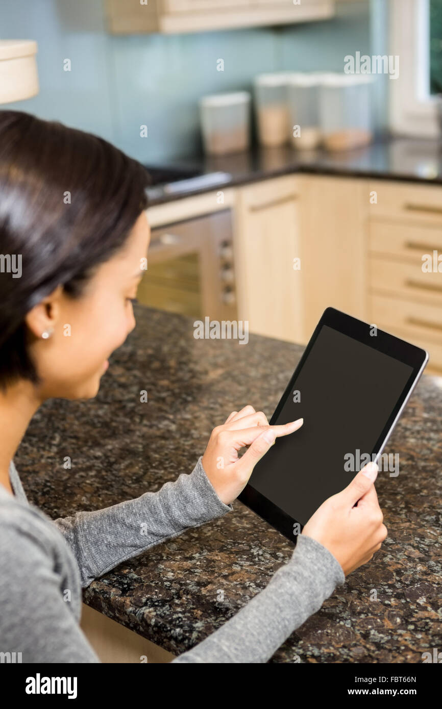 Brunette using tablet with black screen Stock Photo
