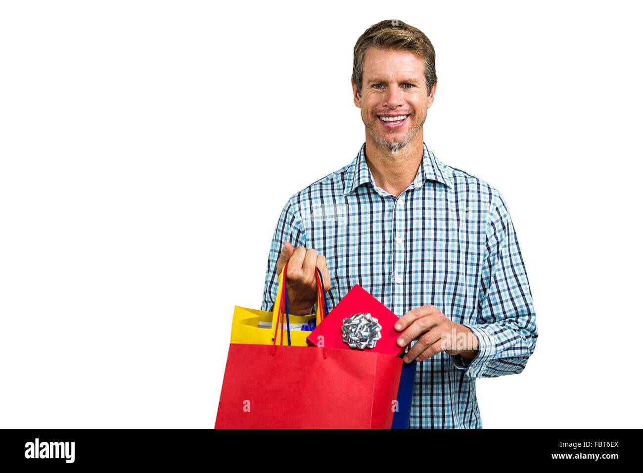 Portrait of man holding shopping bags Stock Photo - Alamy