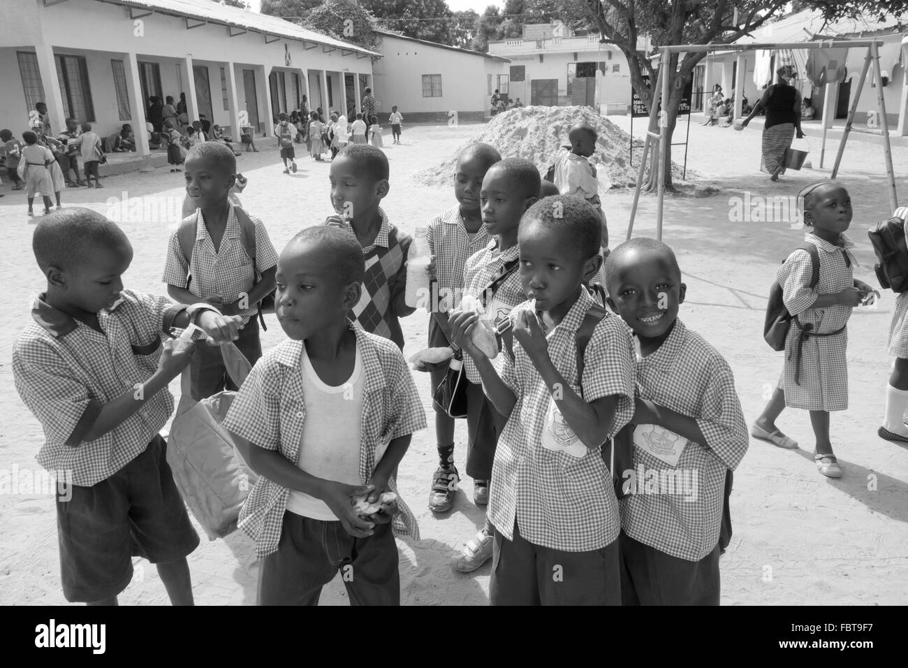 Lunch break for black infant children at a charity run school in the back streets of Kololi Gambia Stock Photo