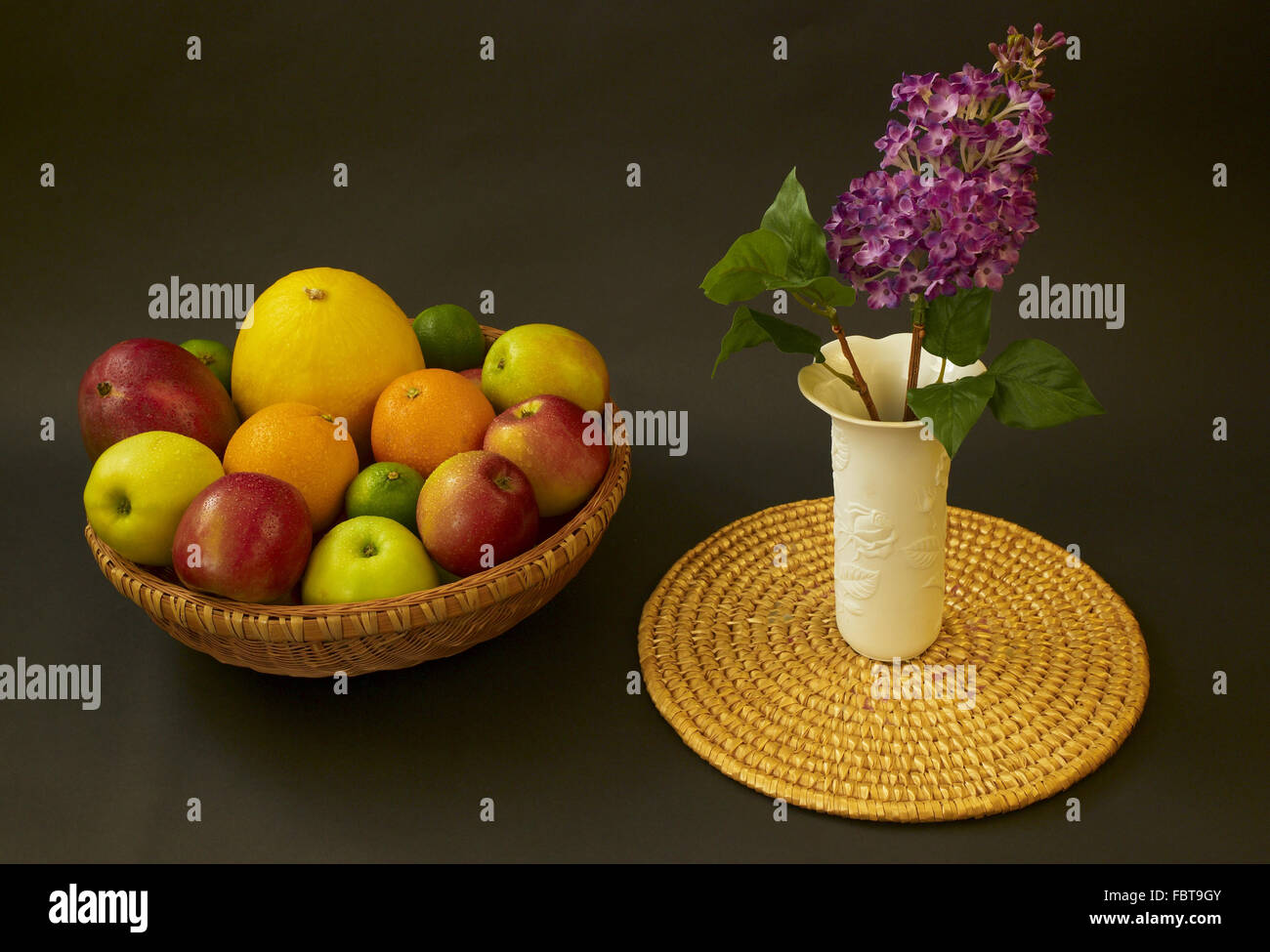 fruit bowle with vase and lilac Stock Photo