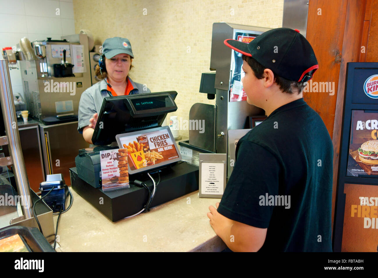 A 10 year old boy ordering fast food at a Burger King outlet Stock Photo