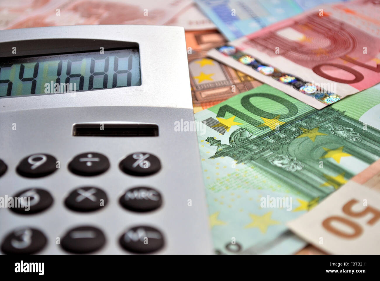 calculator over banknotes Stock Photo