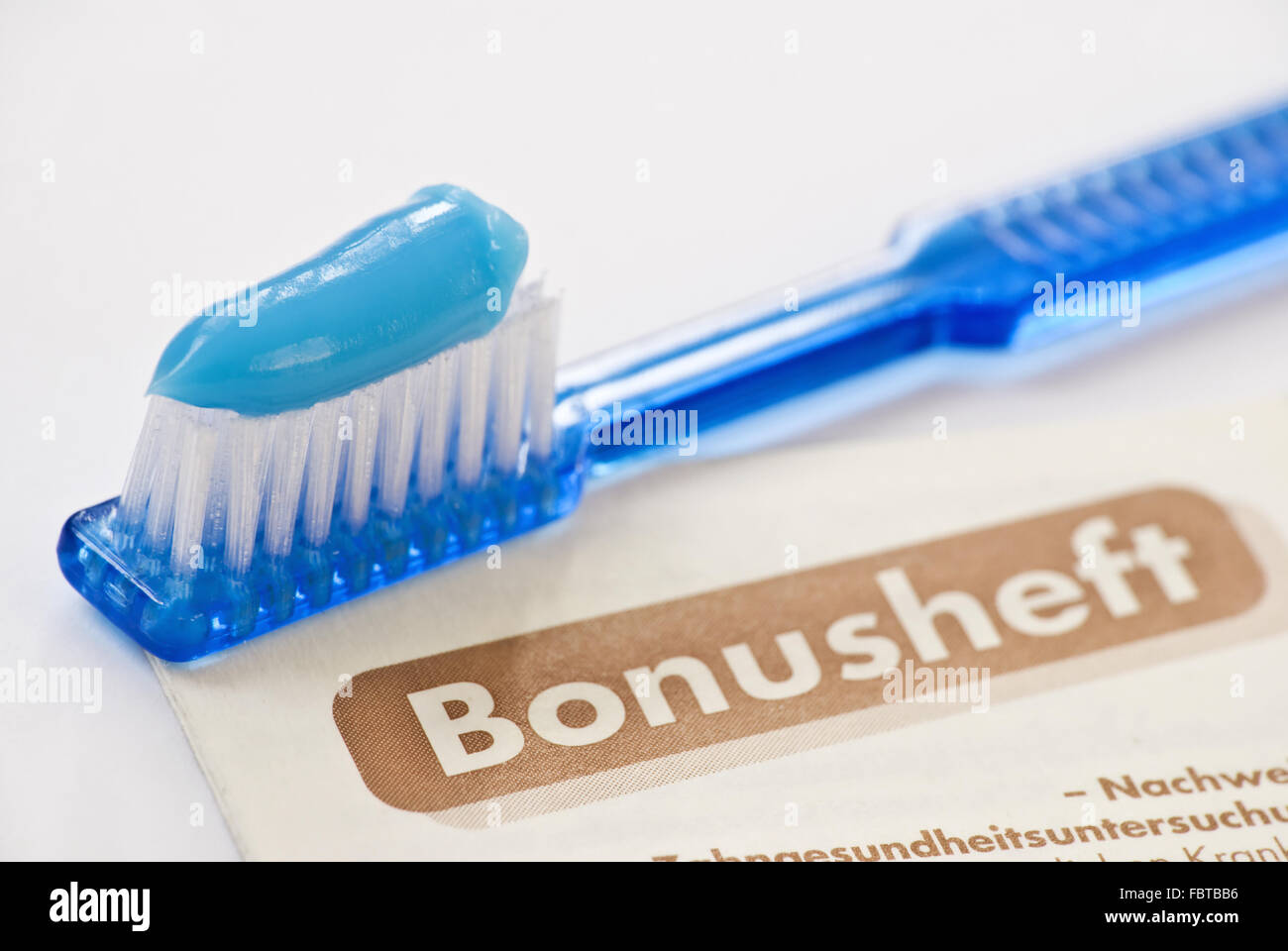 toothbrush and german bonusheft Stock Photo