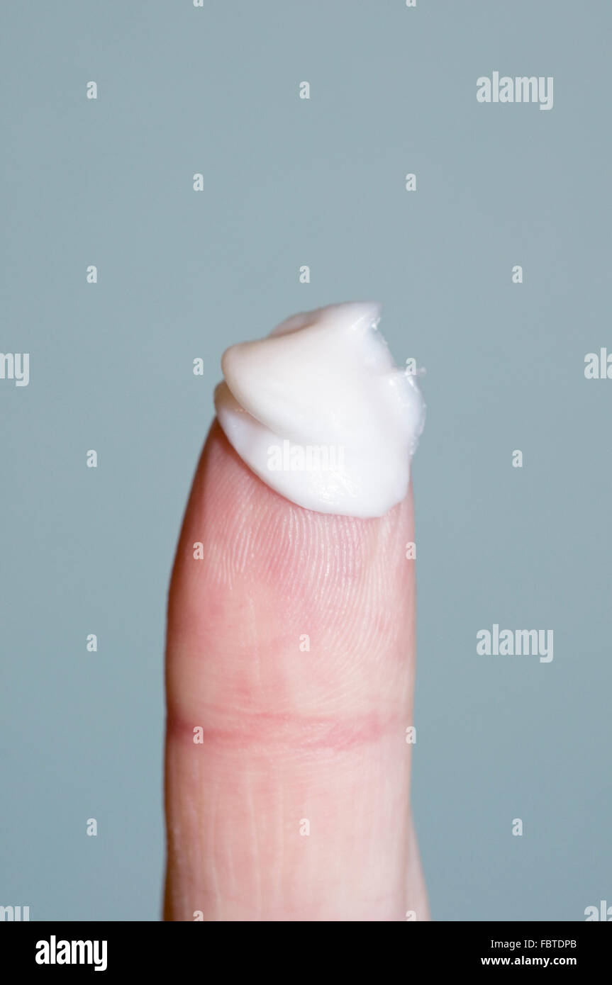 finger with lotion cream on it Stock Photo