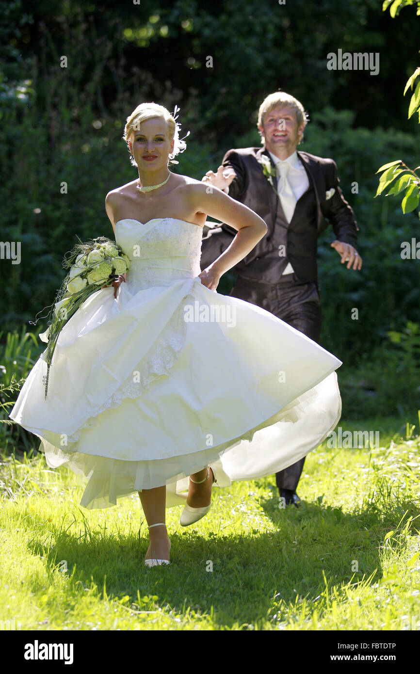 Couple running on a meadow Stock Photo