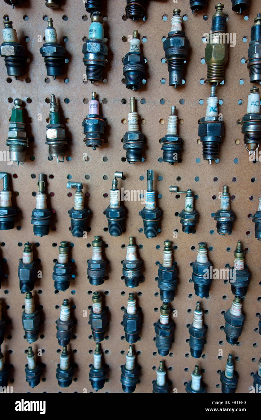 A display of antique spark plugs on a board Stock Photo