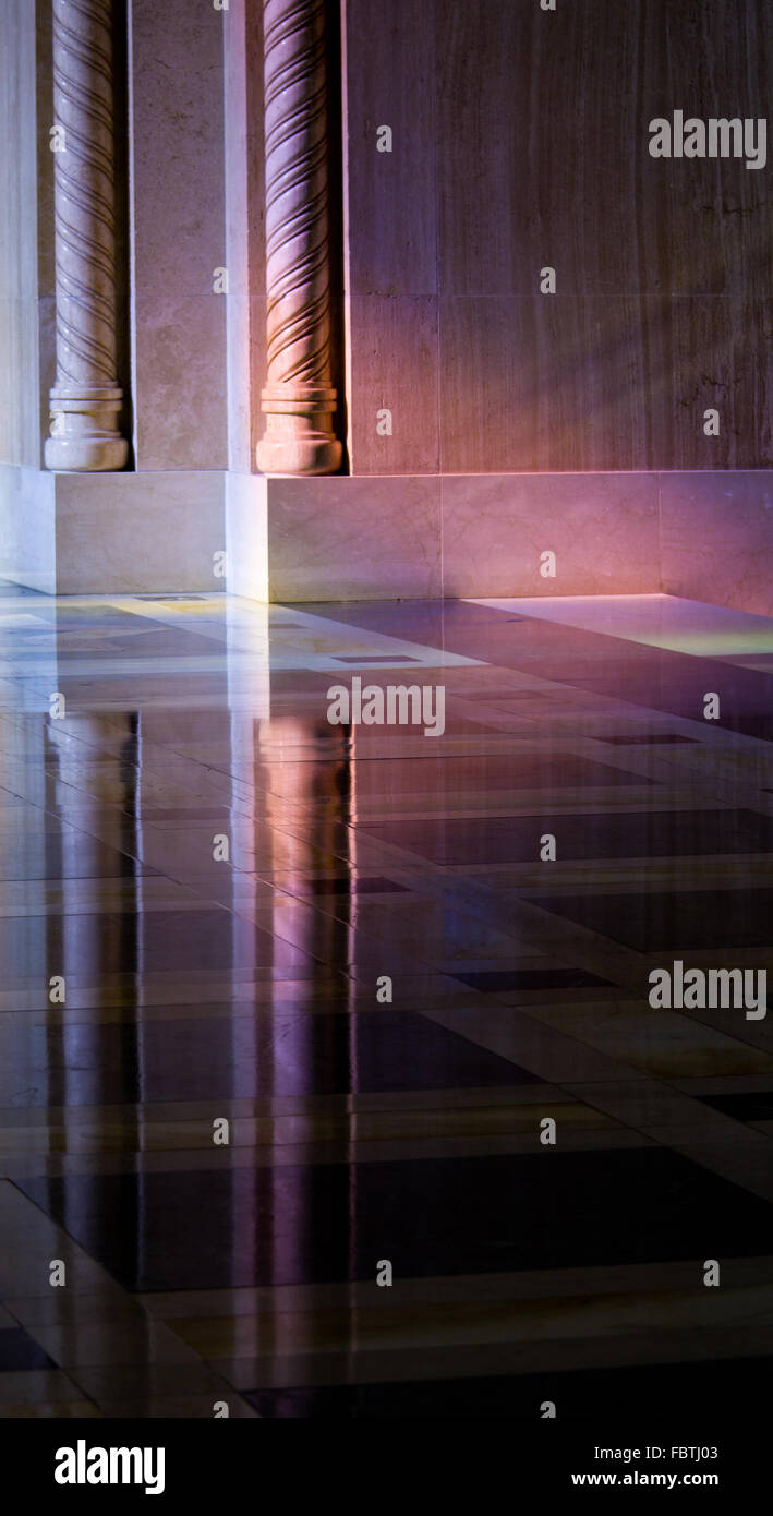 Light from stained glass windows on wall of church Stock Photo