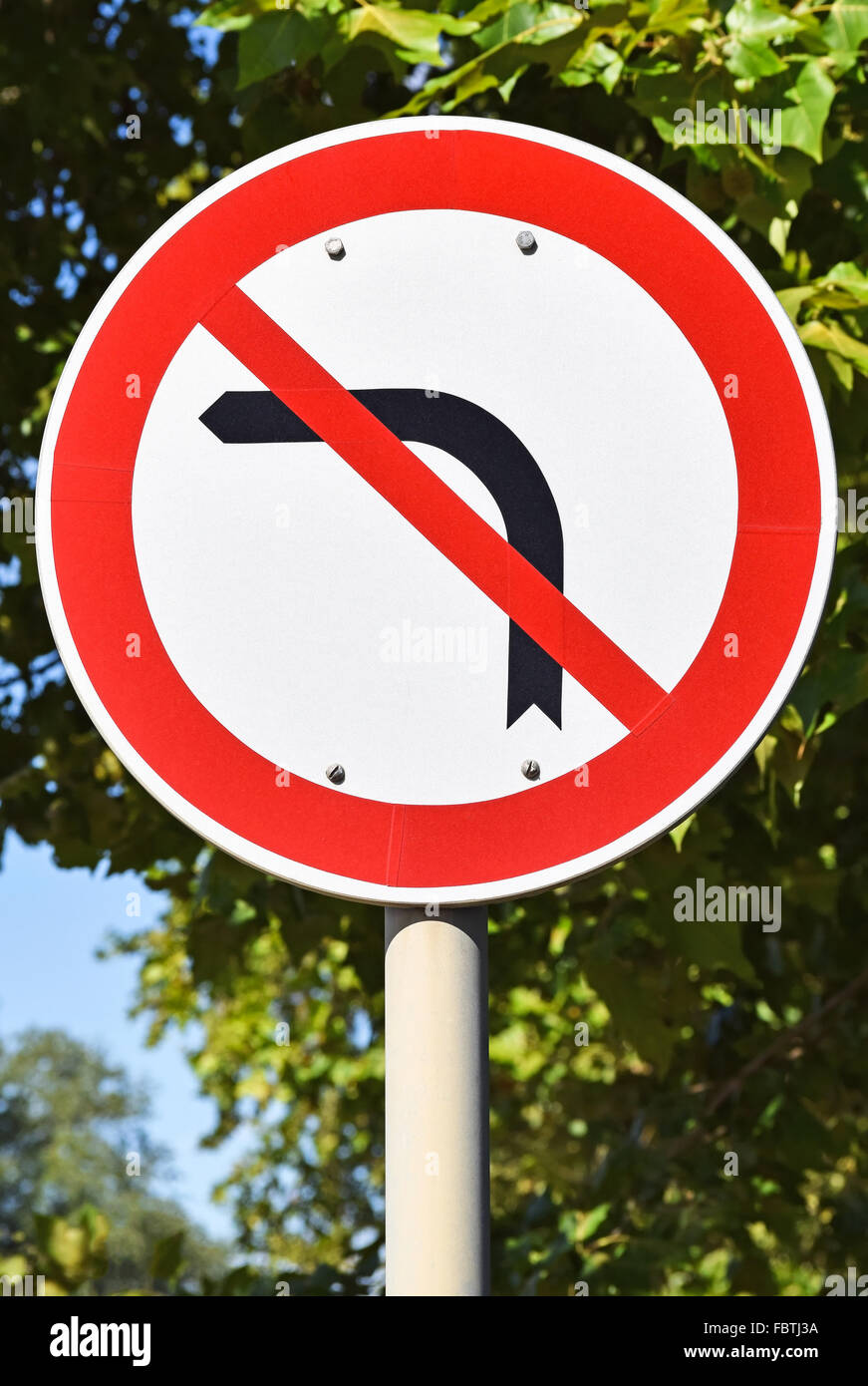 No left turn traffic sign on the road Stock Photo