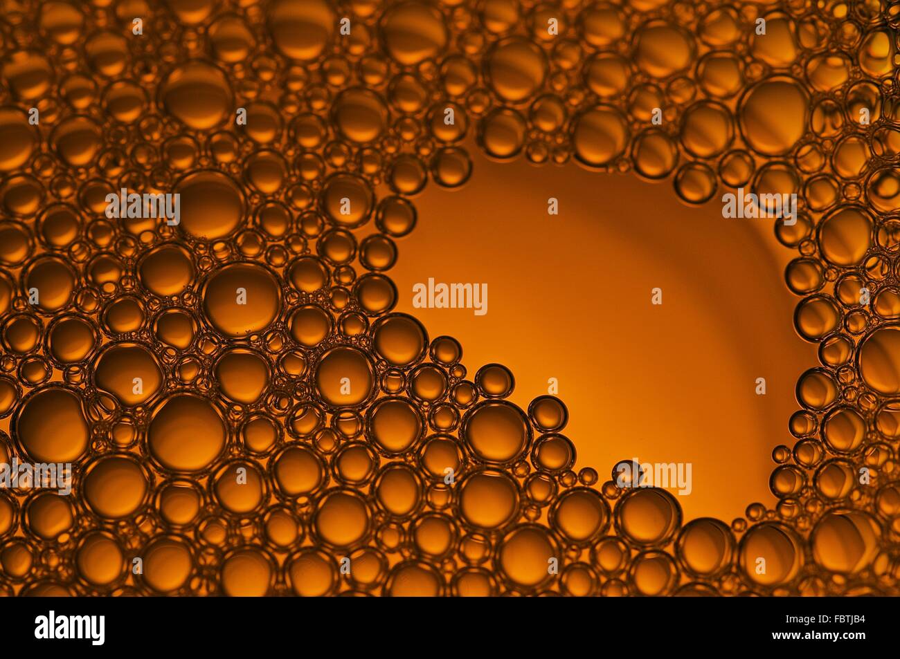 Bubbles on an orange Liquid Stock Photo